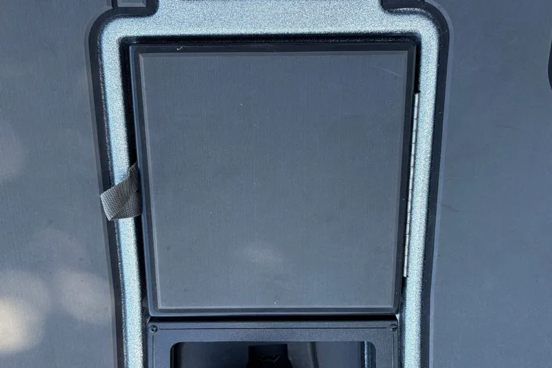 Slide: The Image of 2026 Nitro Z19 XL boat compartment with secure latch and textured surface. - 25