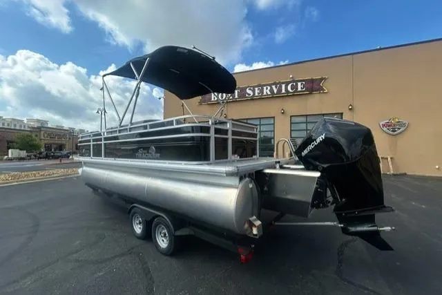 Slide: The Image of 2026 Sun Tracker SportFish 22 XP3 pontoon boat with canopy at boat service center. - 1