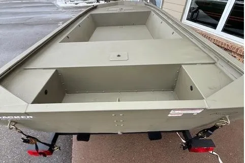 Slide: The Image of 2026 Tracker Grizzly 1648 Utility boat, olive green, parked outdoors. - 2