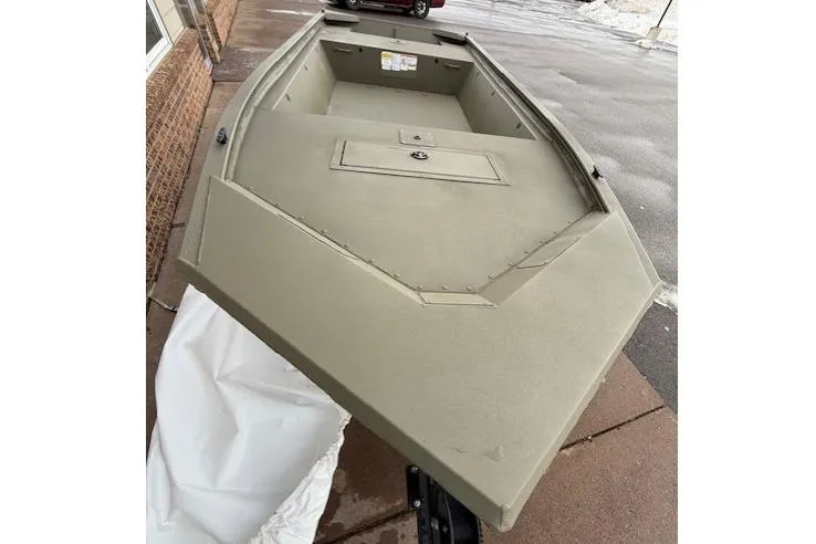 Slide: The Image of 2026 Tracker Grizzly 1648 Utility boat on pavement, showcasing its spacious interior and sturdy design. - 3