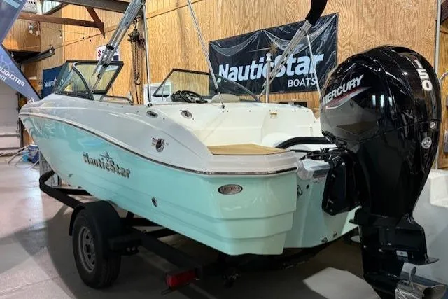 Slide: The Image of 2023 NauticStar 203 DC boat with Mercury engine displayed indoors. - 3
