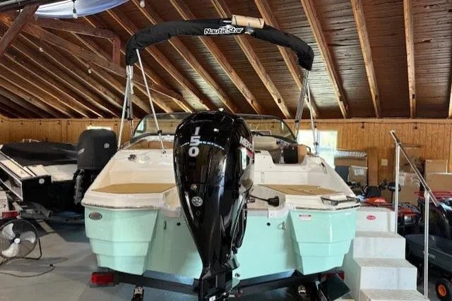 Slide: The Image of 2023 NauticStar 203 DC boat with Mercury engine in a wooden boathouse. - 5