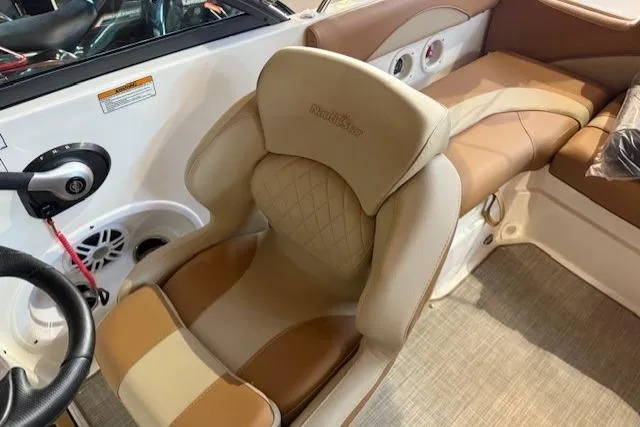 Slide: The Image of 2023 NauticStar 203 DC boat interior with tan seating and steering wheel. - 8
