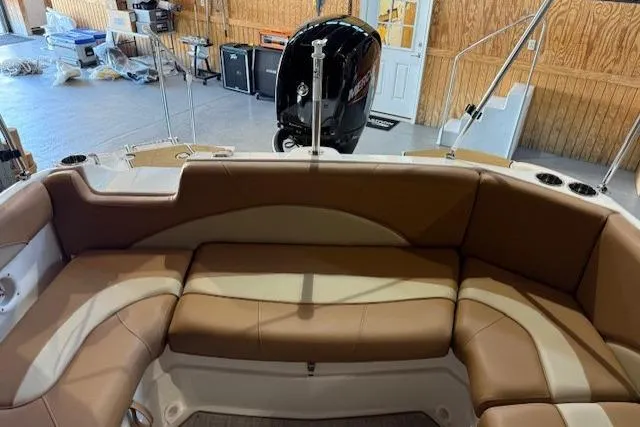 Slide: The Image of 2023 NauticStar 203 DC boat interior with tan seating and visible outboard motor. - 9
