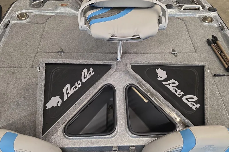 Slide: The Image of 2023 Bass Cat Caracal boat interior with storage compartments and seating. - 10