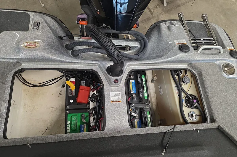 Slide: The Image of 2023 Bass Cat Caracal boat showing battery compartments and engine components. - 13