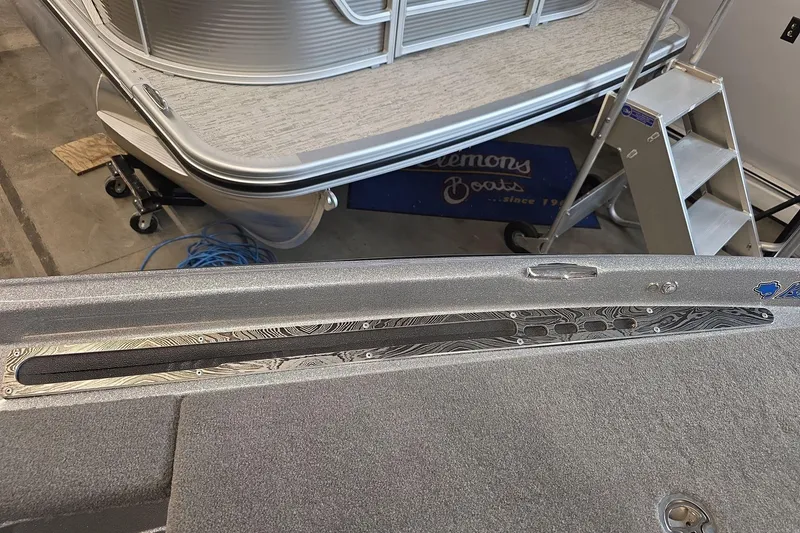 Slide: The Image of 2023 Bass Cat Caracal boat interior with detailed deck design in a showroom. - 15