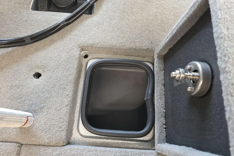 Slide: The Image of 2023 Bass Cat Caracal boat interior storage compartment with latch detail. - 17