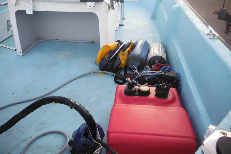 Slide: The Image of Interior of a 1998 Maritime Skiff 18 with boating equipment and red fuel tank. - 12