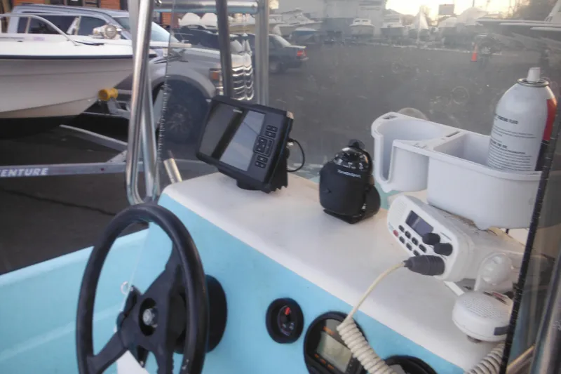 Slide: The Image of Interior of a 1998 Maritime Skiff 18 with steering wheel and navigation equipment. - 17