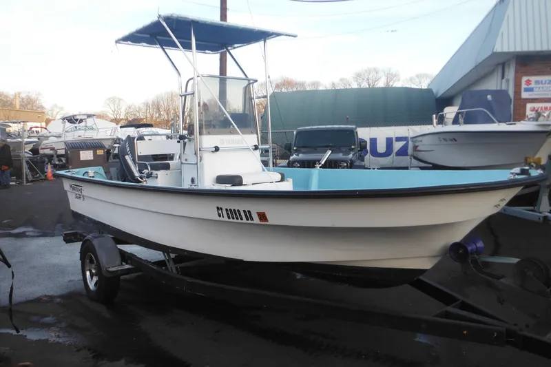 Slide: The Image of 1998 Maritime Skiff 18 boat on trailer in marina setting. - 20