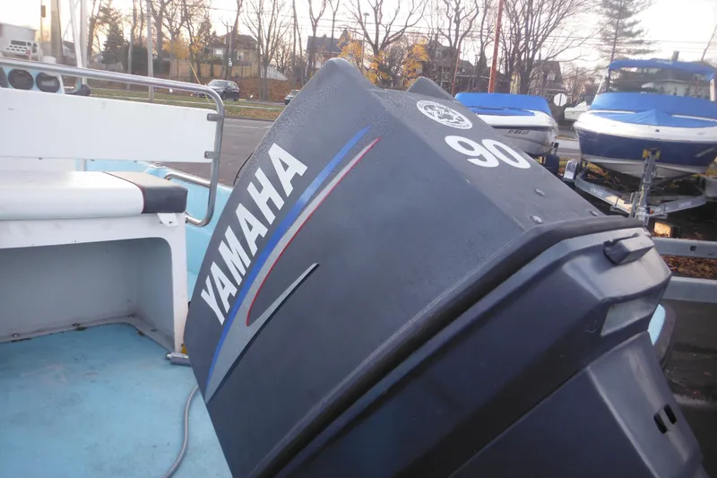Slide: The Image of 1998 Maritime Skiff 18 with Yamaha 90 outboard motor in a boatyard. - 5