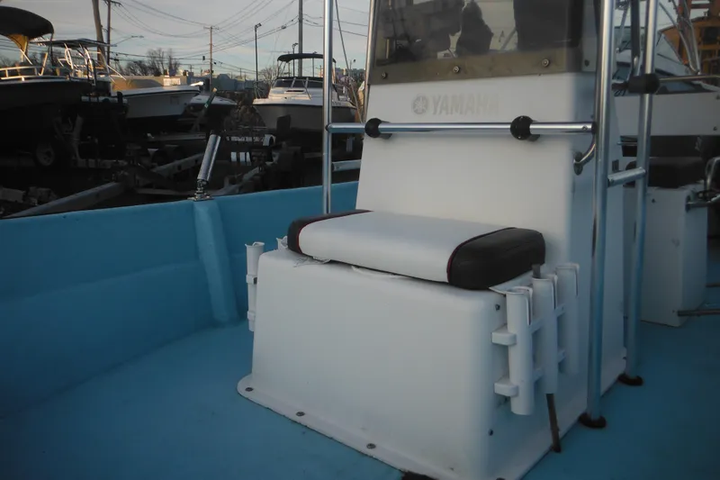 Slide: The Image of 1998 Maritime Skiff 18 with Yamaha console, docked among other boats. - 7