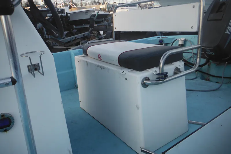 Slide: The Image of 1998 Maritime Skiff 18 interior with seating and steering console. - 9
