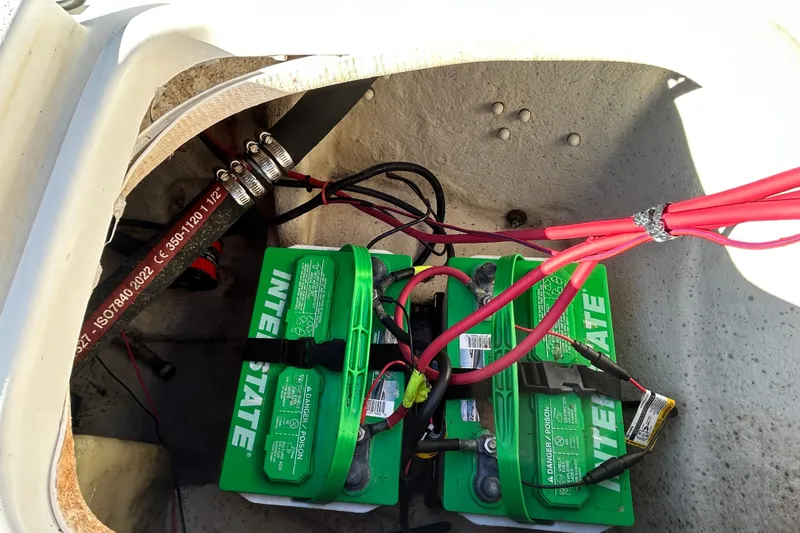 Slide: The Image of Battery compartment of a 2014 Carolina Skiff 258 DLV with Interstate batteries and wiring. - 12