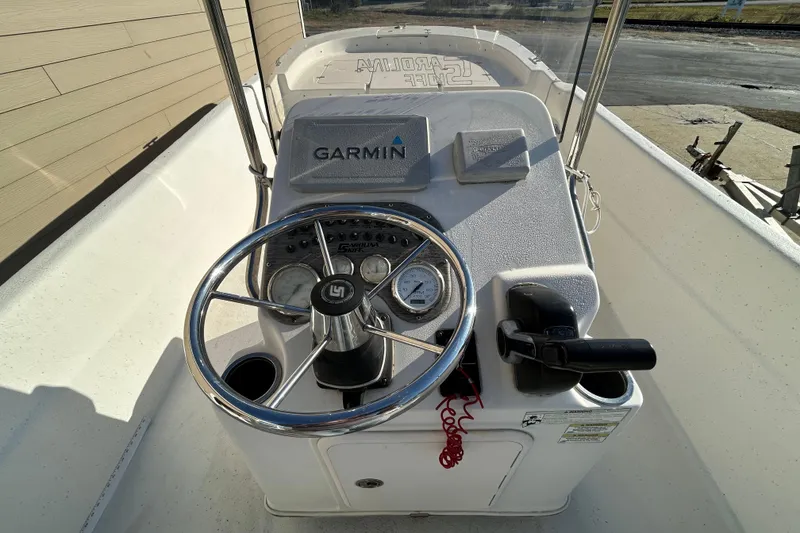 Slide: The Image of 2014 Carolina Skiff 258 DLV boat console with Garmin navigation system and steering wheel. - 14