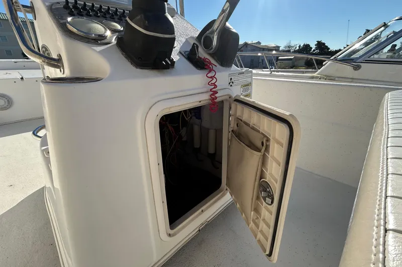 Slide: The Image of 2014 Carolina Skiff 258 DLV boat console with open storage compartment. - 19