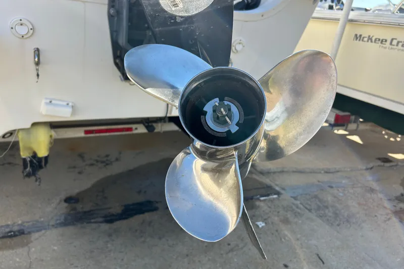 Slide: The Image of 2014 Carolina Skiff 258 DLV boat propeller close-up, showcasing shiny metal blades. - 23
