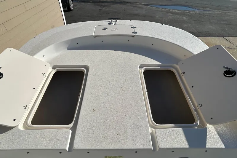 Slide: The Image of 2014 Carolina Skiff 258 DLV boat deck with open storage compartments. - 7