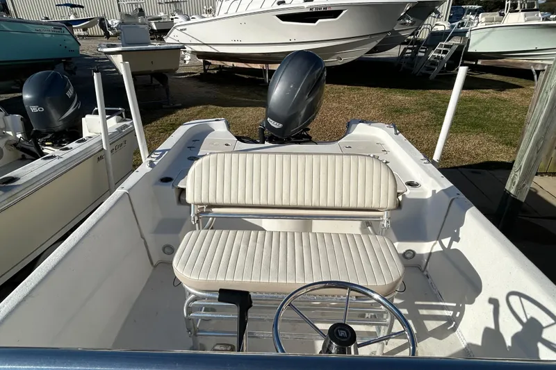 Slide: The Image of 2014 Carolina Skiff 258 DLV boat interior with seating and steering wheel. - 9
