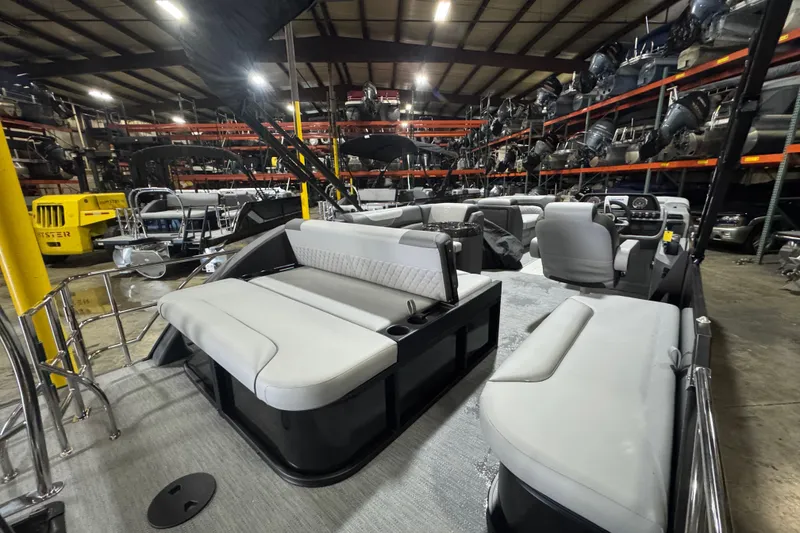 Slide: The Image of 2026 Godfrey Sweetwater 2286 SFL pontoon boat in warehouse, showcasing spacious seating and modern design. - 11