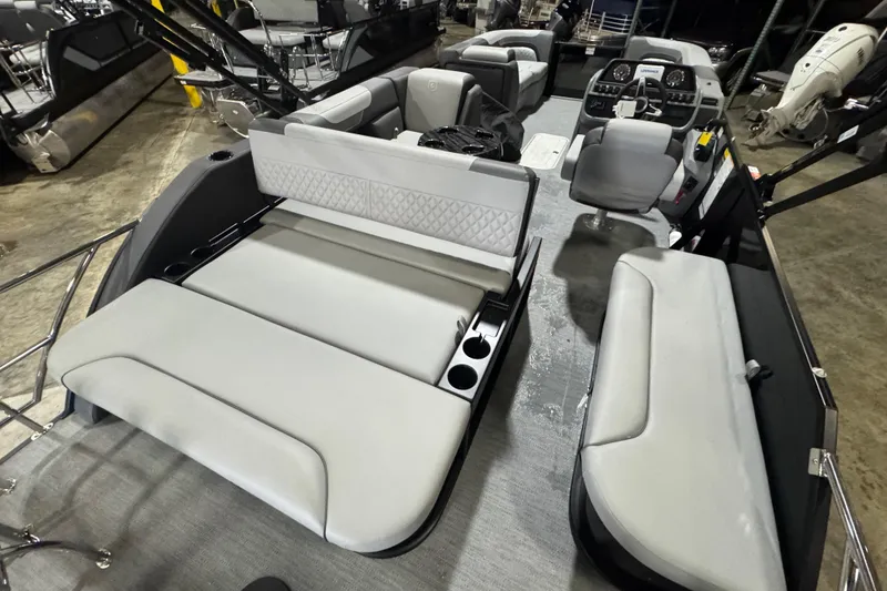 Slide: The Image of 2026 Godfrey Sweetwater 2286 SFL pontoon boat interior with plush seating and modern dashboard. - 12