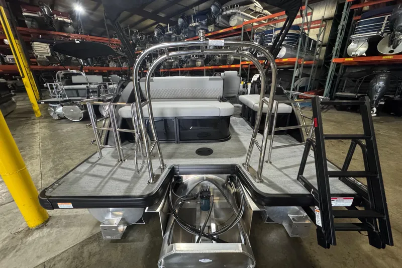 Slide: The Image of 2026 Godfrey Sweetwater 2286 SFL pontoon boat in warehouse, rear view with seating and ladder. - 14
