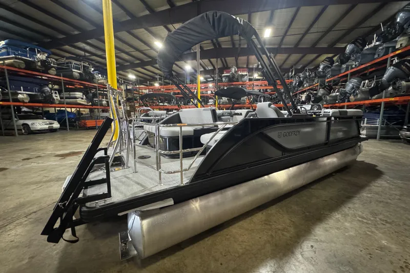 Slide: The Image of 2026 Godfrey Sweetwater 2286 SFL pontoon boat in warehouse, showcasing sleek design and seating. - 3