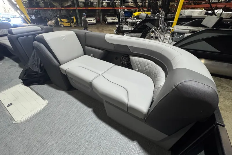 Slide: The Image of 2026 Godfrey Sweetwater 2286 SFL boat interior with luxurious gray seating in a showroom. - 5