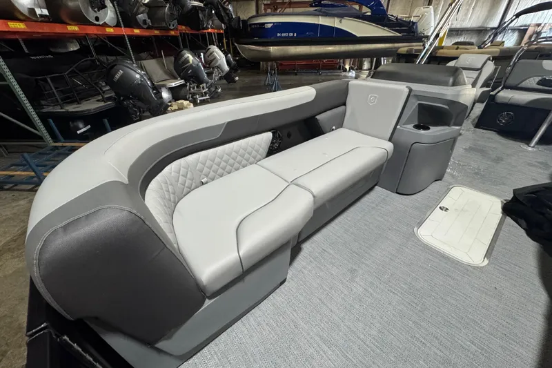 Slide: The Image of 2026 Godfrey Sweetwater 2286 SFL boat interior with gray seating and storage compartments. - 6