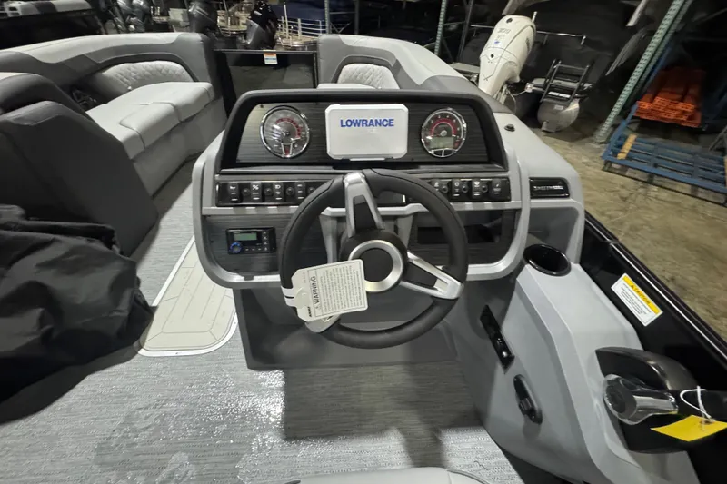Slide: The Image of 2026 Godfrey Sweetwater 2286 SFL boat interior with steering wheel and dashboard controls. - 9