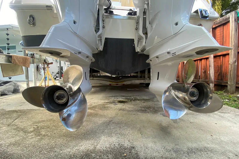 Slide: The Image of 2004 Grady-White Canyon 283 boat with dual outboard propellers, docked on concrete. - 17