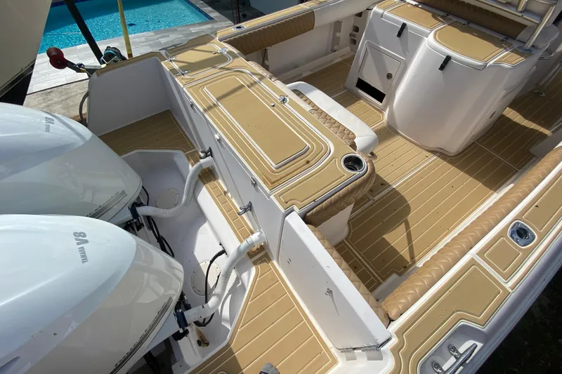 Slide: The Image of 2004 Grady-White Canyon 283 boat interior with twin Yamaha engines, near a pool. - 23