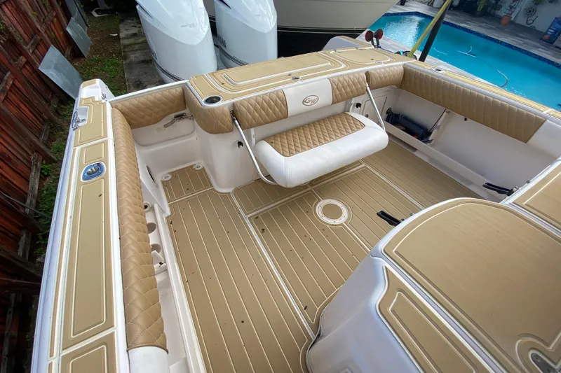 Slide: The Image of 2004 Grady-White Canyon 283 boat interior with tan upholstery and spacious deck. - 26