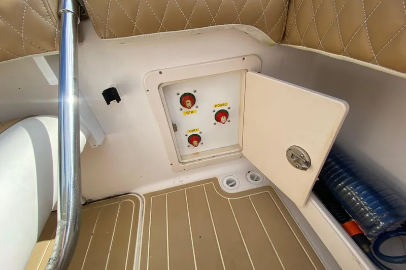 Slide: The Image of Control panel on 2004 Grady-White Canyon 283 boat with switches and storage compartment. - 32