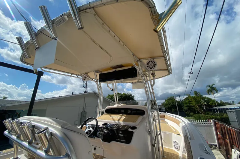 Slide: The Image of 2004 Grady-White Canyon 283 boat with T-top and rod holders under a cloudy sky. - 37