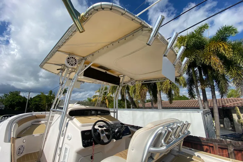 Slide: The Image of 2004 Grady-White Canyon 283 boat with canopy, steering console, and rod holders. - 38