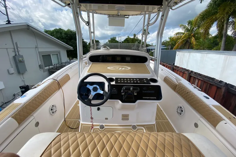 Slide: The Image of 2004 Grady-White Canyon 283 boat interior with steering wheel and control panel. - 39