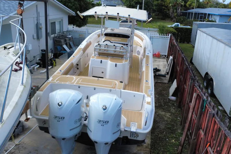Slide: The Image of 2004 Grady-White Canyon 283 boat with dual Yamaha 350 V8 engines in a driveway. - 4