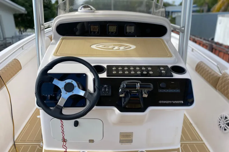 Slide: The Image of 2004 Grady-White Canyon 283 boat console with steering wheel and control panel. - 40