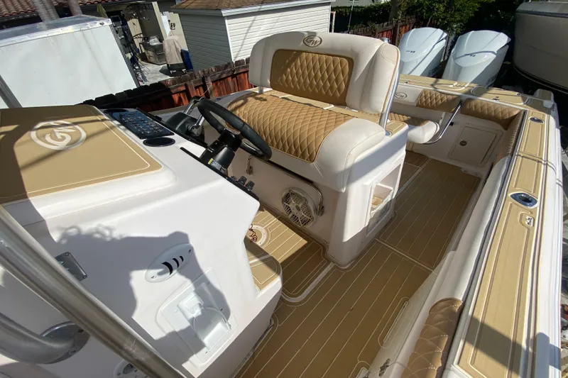 Slide: The Image of 2004 Grady-White Canyon 283 boat interior with tan and white seating and helm. - 48