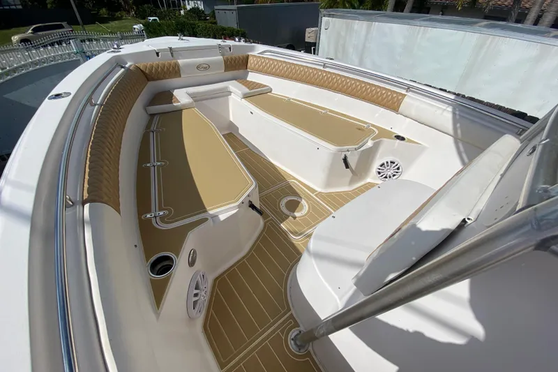 Slide: The Image of 2004 Grady-White Canyon 283 boat interior with tan seating and deck. - 49