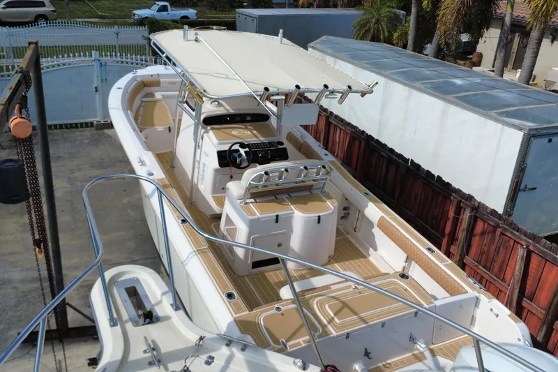 Slide: The Image of 2004 Grady-White Canyon 283 boat with spacious deck and modern helm station. - 5