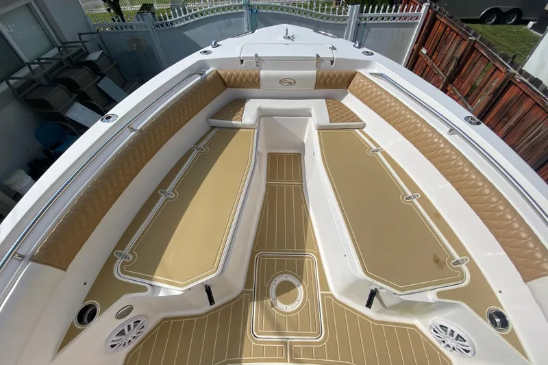 Slide: The Image of 2004 Grady-White Canyon 283 boat interior with tan seating and deck. - 50