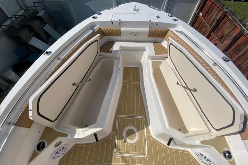 Slide: The Image of 2004 Grady-White Canyon 283 boat interior with open storage compartments and cushioned seating. - 51