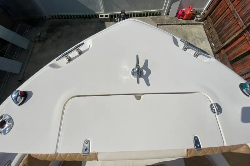 Slide: The Image of 2004 Grady-White Canyon 283 boat deck with cleats and hatch, docked in a marina. - 54