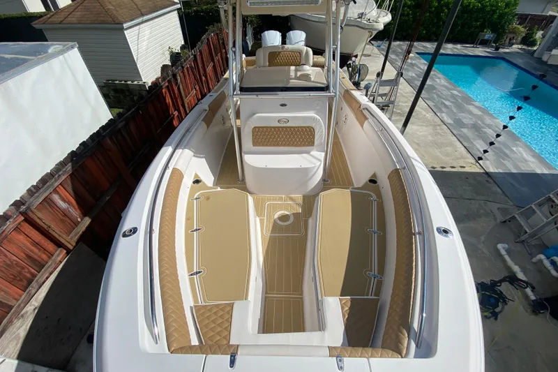 Slide: The Image of 2004 Grady-White Canyon 283 boat with tan seating, docked near a pool. - 55