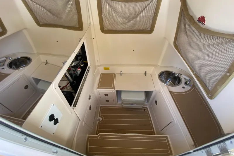 Slide: The Image of 2004 Grady-White Canyon 283 cabin interior with sink, storage, and compact design. - 58