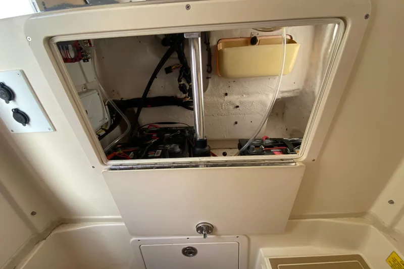 Slide: The Image of 2004 Grady-White Canyon 283 boat interior showing battery compartment and wiring. - 60