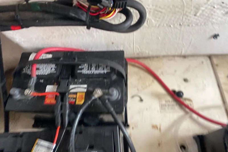 Slide: The Image of Battery setup in a 2004 Grady-White Canyon 283 boat, featuring wiring and connections. - 62
